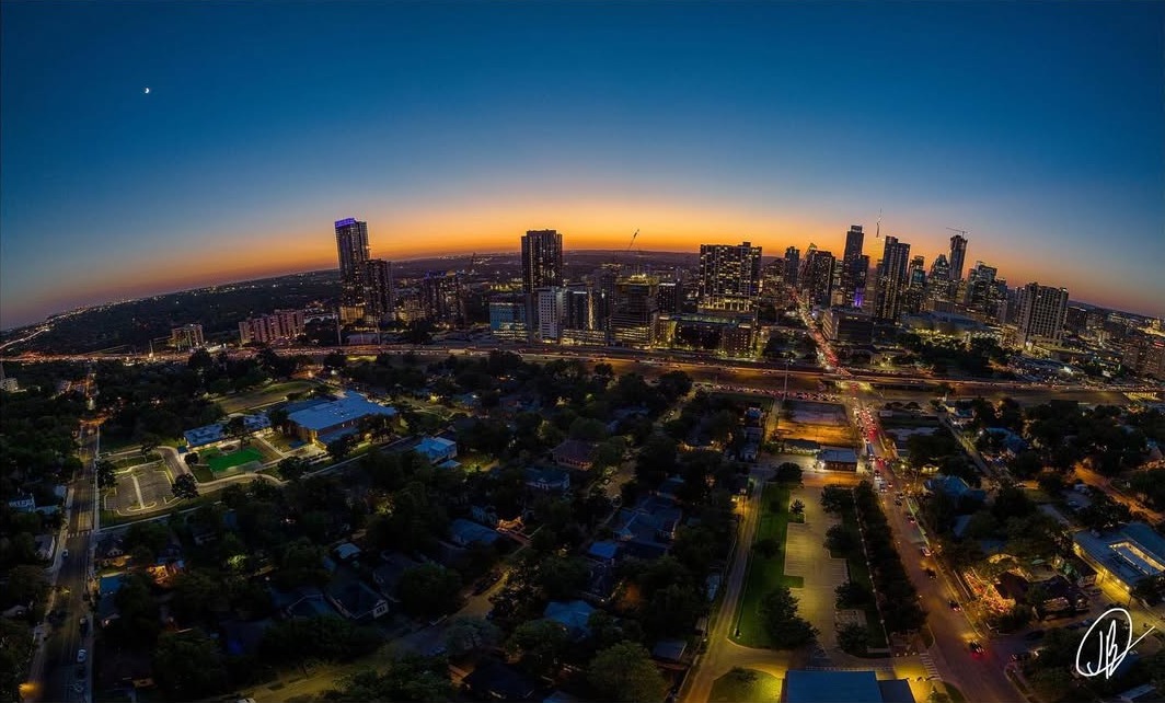 Aerial Showcase - Panoramic aerial view of city skyline at sunset with dramatic fisheye perspective