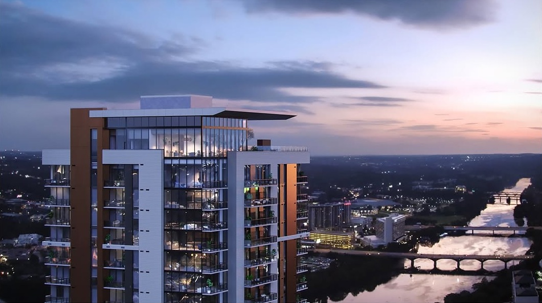 Urban Perspectives - Aerial drone view of a modern high-rise building at dusk with a river and cityscape in the background
